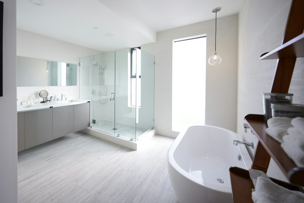 Modern domestic bathroom with shower cabin and freestanding bath, sunlight, no people